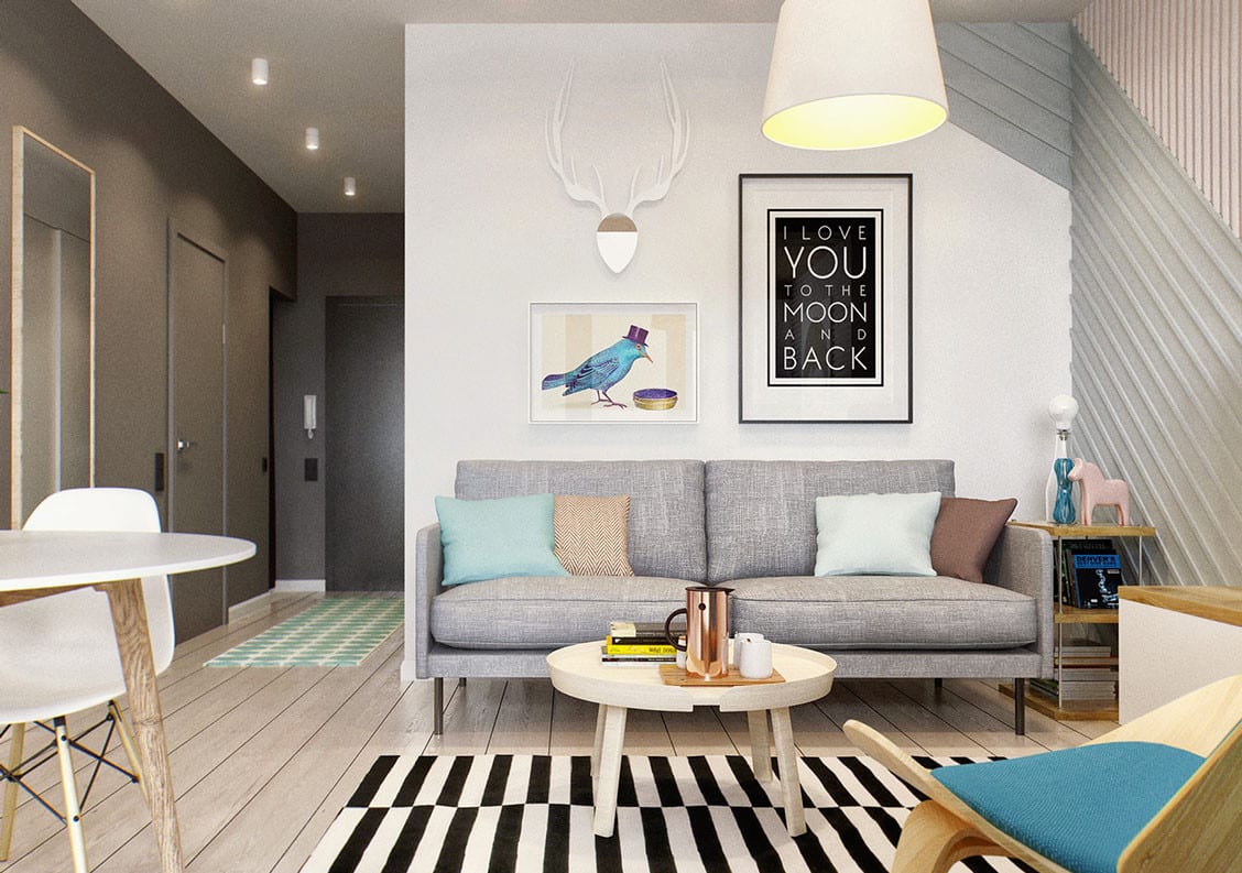kleines wohnzimmer einrichten mit rundem couchtisch weiß vor sofa grau, pendellampe weiß, teppich mit schwarzweißen streifen und Wandfarbe grau